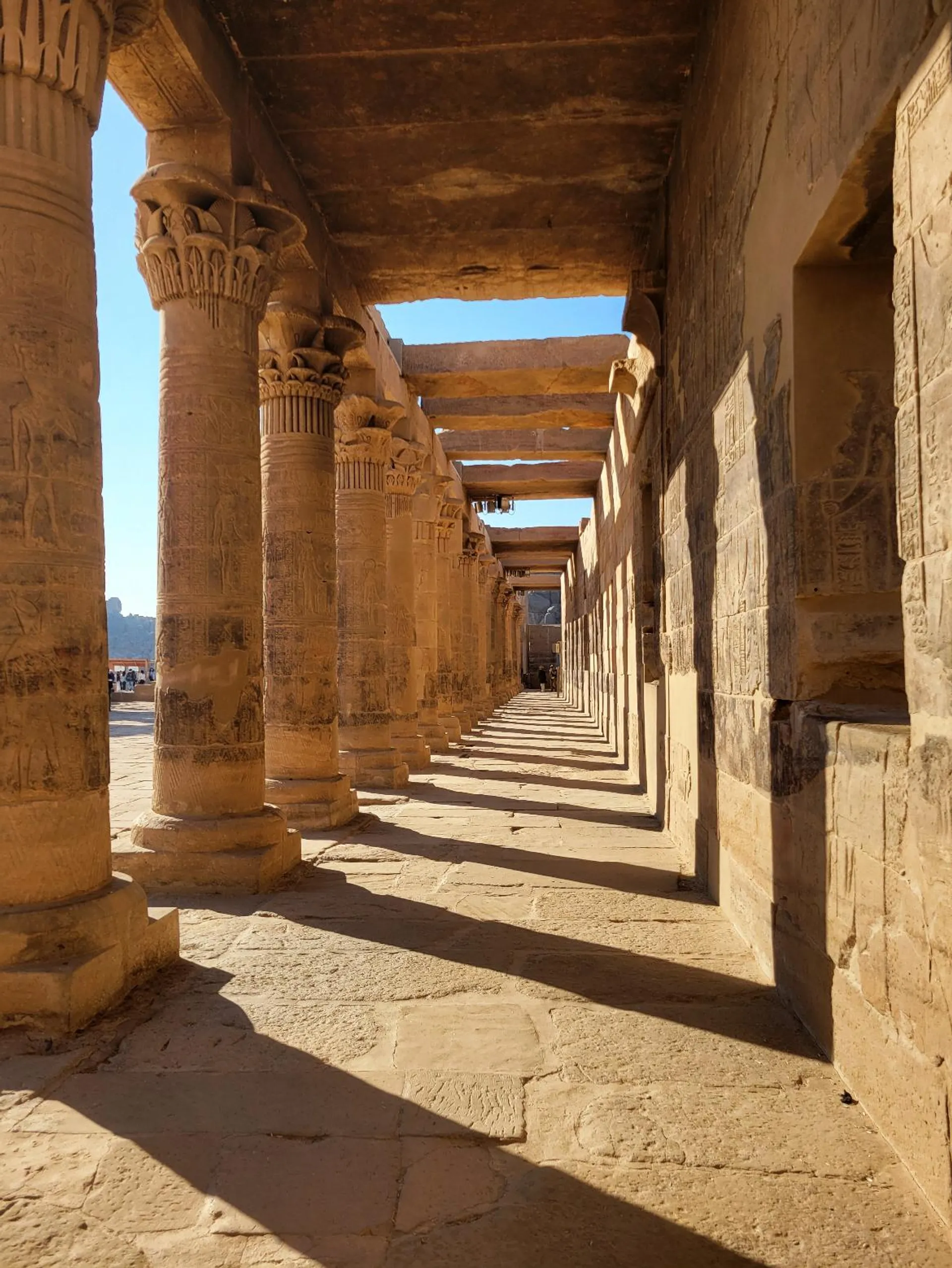 Colonnade d'un temple de Haute-Égypte en lumière rasante